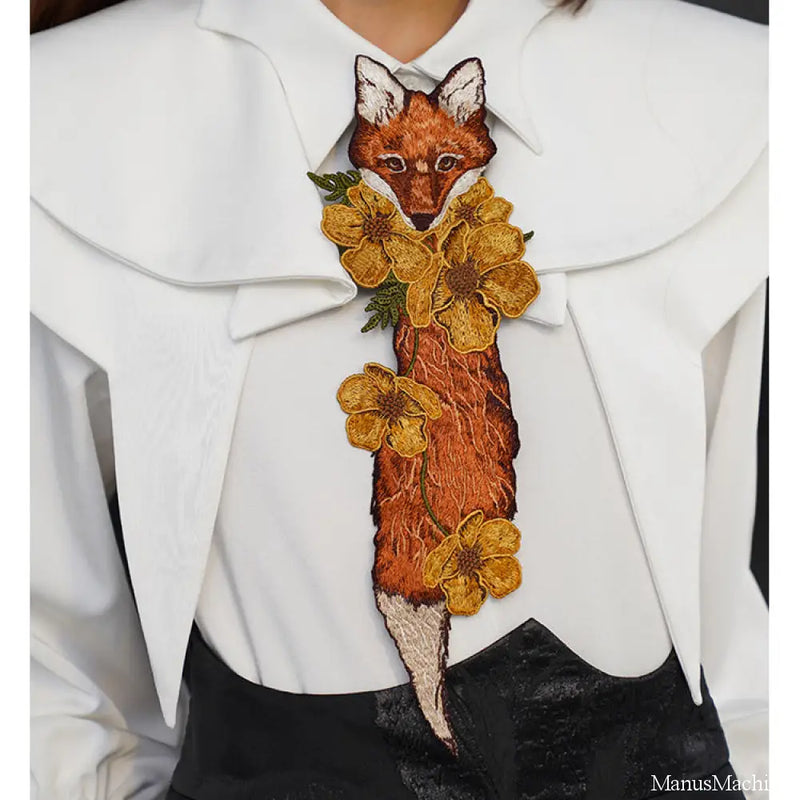 Embroidered tie of a fox playing with flowers