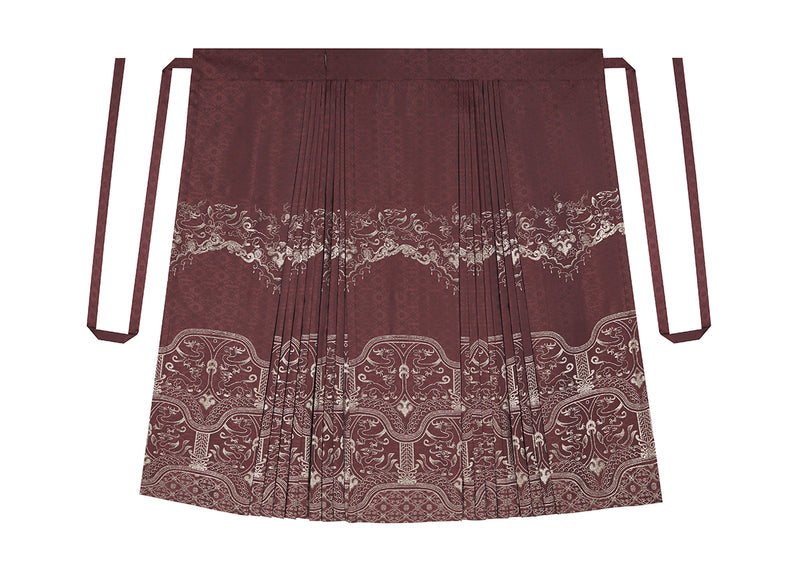 鳥獣文様柄のロングプリーツスカートと幾何学柄の刺繍羽織りとハイネックトップス