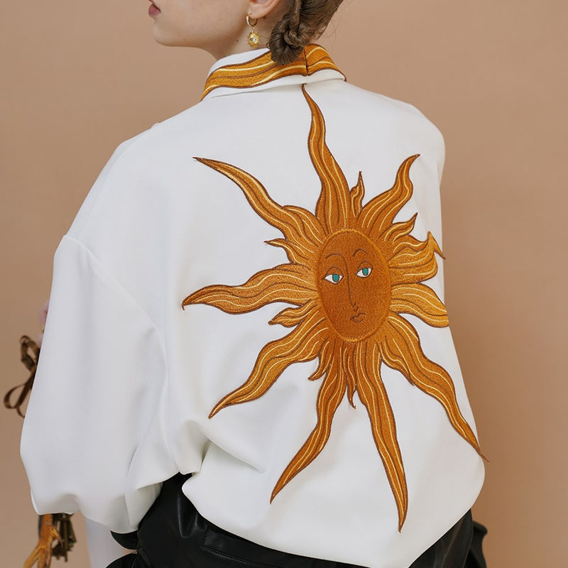 swirling sun embroidered blouse