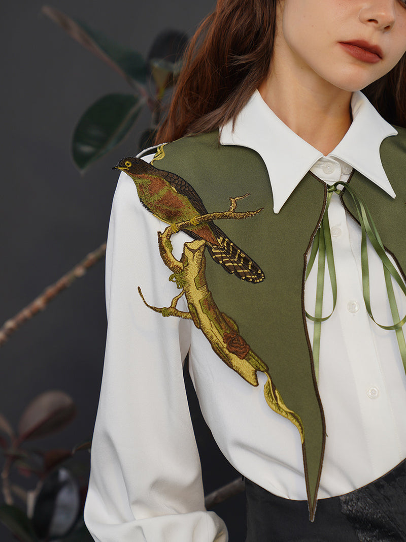 Embroidered bustier of a small bird perched on a branch