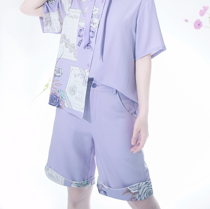 A light mauve blouse and shorts with a letter and a bouquet