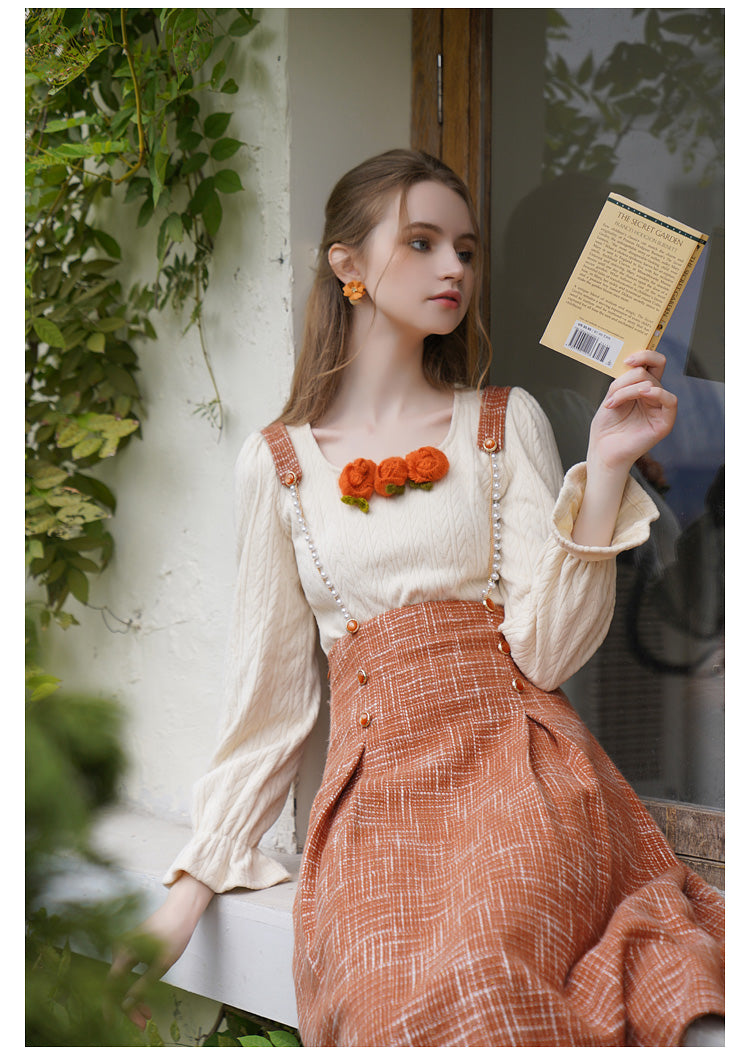 Orange blooming knit top and suspender skirt 