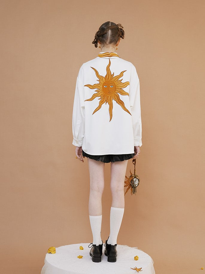 swirling sun embroidered blouse